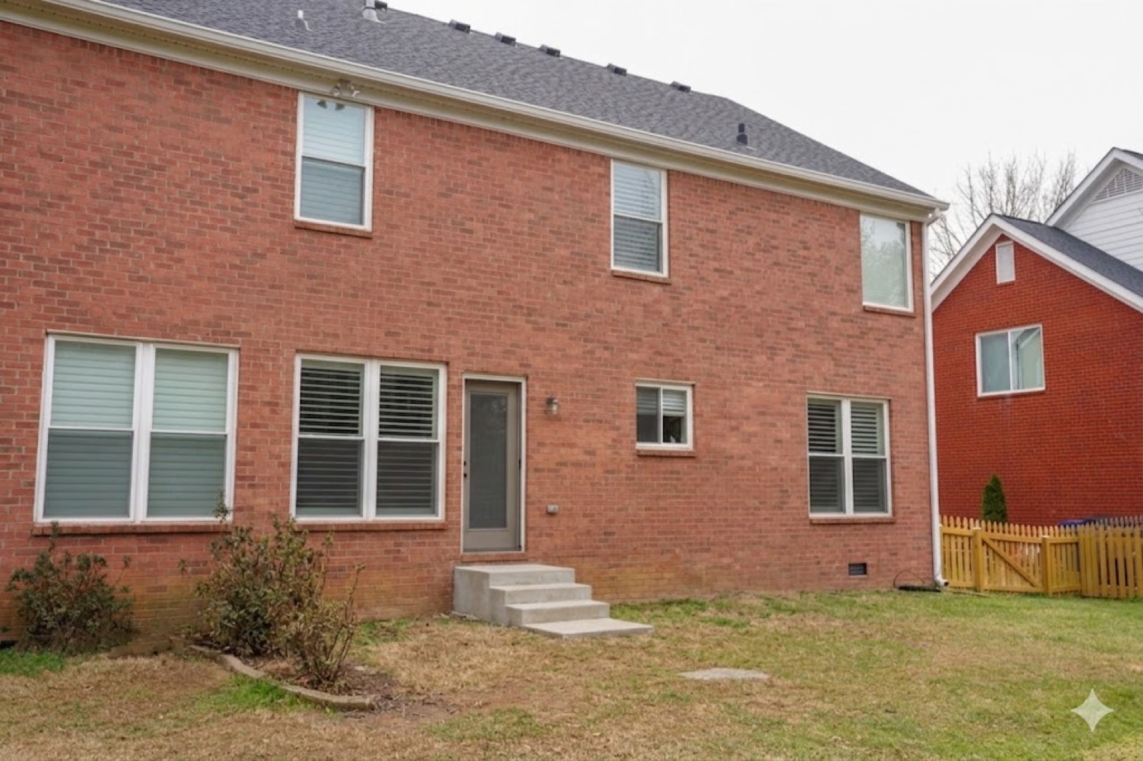 Before — back of the brick house, no porch yet
